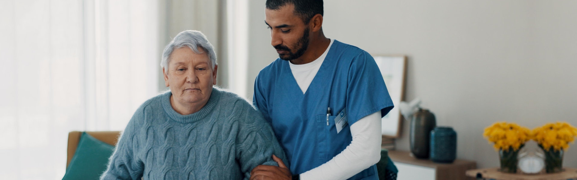 nurse assisting senior woman